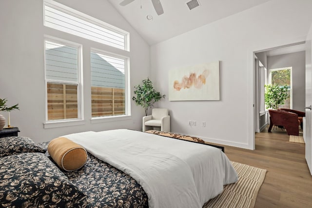 bedroom featuring ceiling fan, light hardwood / wood-style floors, and vaulted ceiling