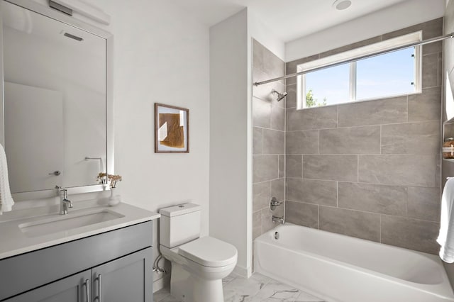 full bathroom featuring tiled shower / bath combo, toilet, and vanity