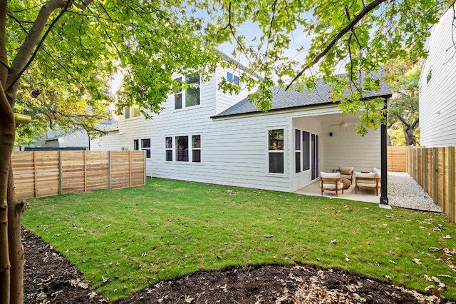 back of property featuring an outdoor living space, a patio area, and a lawn