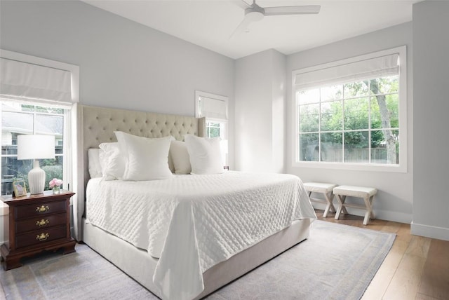 bedroom with ceiling fan and light hardwood / wood-style floors