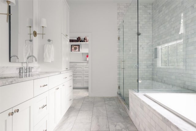 bathroom featuring separate shower and tub and vanity