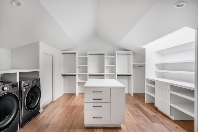 walk in closet featuring lofted ceiling, light wood-type flooring, and independent washer and dryer