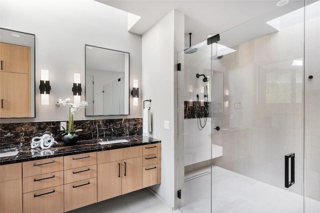 bathroom with a stall shower, vanity, and decorative backsplash