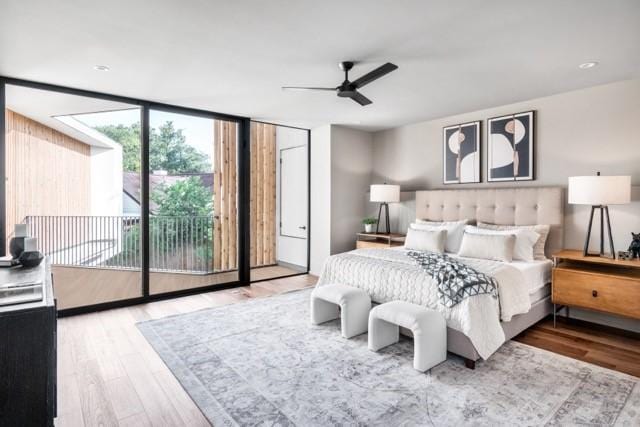 bedroom featuring access to exterior, ceiling fan, a wall of windows, and wood finished floors