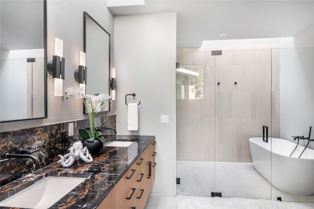 bathroom with a sink, a shower stall, decorative backsplash, and double vanity