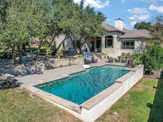 view of swimming pool with a patio