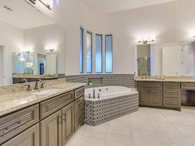 bathroom with tile patterned flooring, vanity, and independent shower and bath