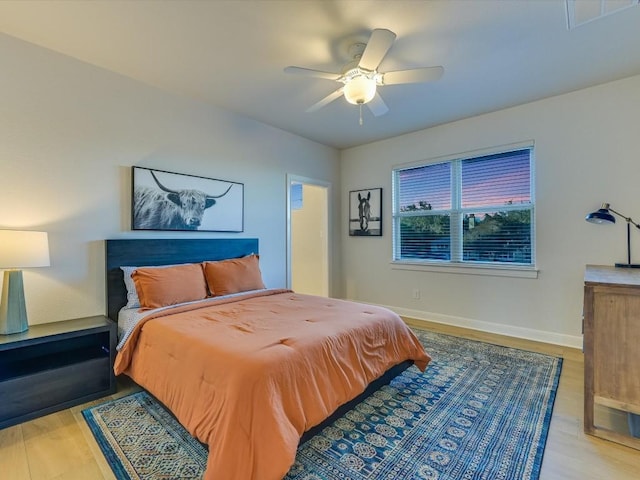 bedroom with ceiling fan and light hardwood / wood-style flooring