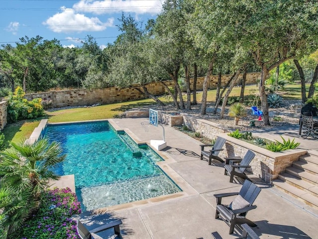 view of pool with pool water feature and a patio area