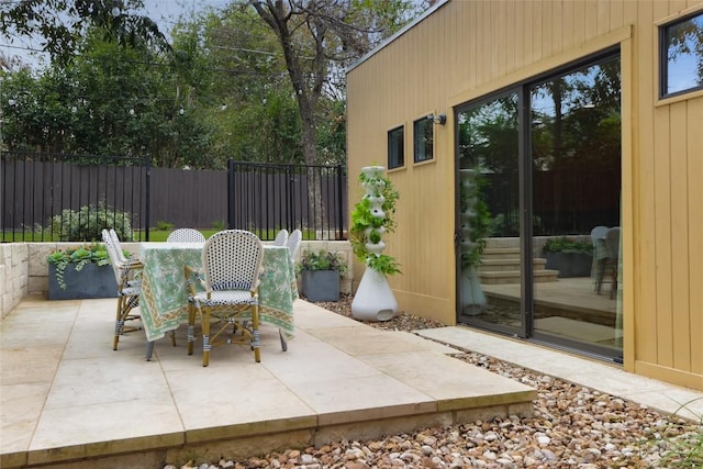 view of patio / terrace featuring outdoor dining area and fence