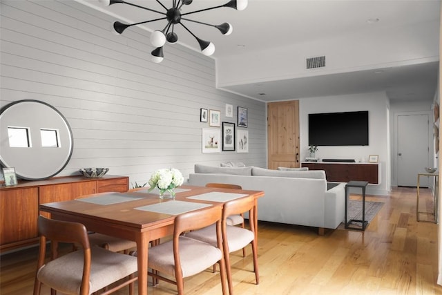 dining room with visible vents and light wood-type flooring