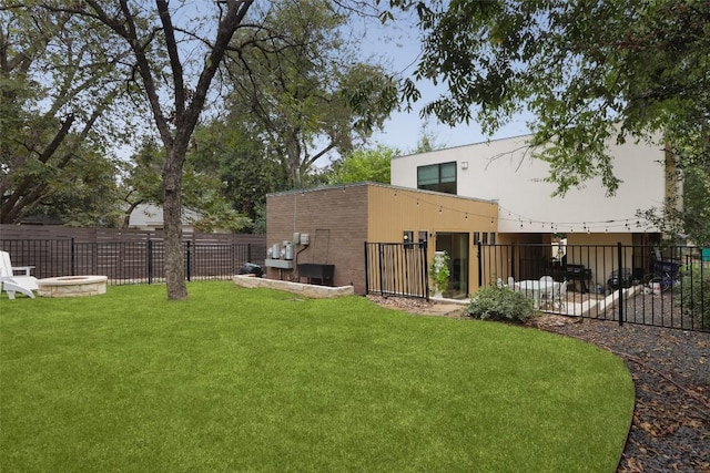 view of yard with an outdoor fire pit and fence