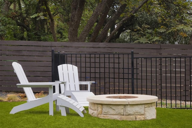 view of patio / terrace with a fire pit and fence