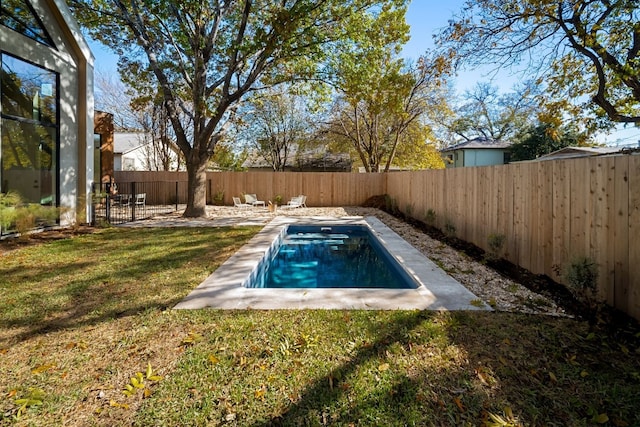 view of pool with a yard