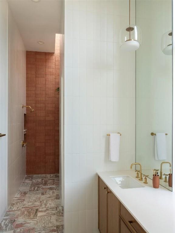 bathroom with vanity, tile walls, and walk in shower