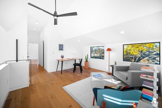 living room with ceiling fan, high vaulted ceiling, and light hardwood / wood-style floors