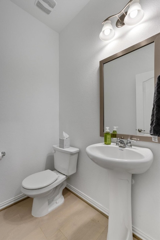 bathroom featuring toilet and sink