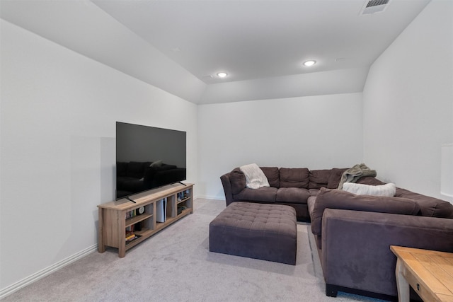 carpeted living room with vaulted ceiling