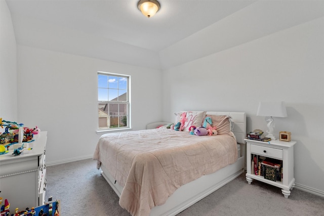 bedroom with vaulted ceiling and carpet floors