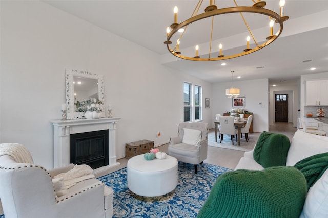 living room with a notable chandelier and light hardwood / wood-style flooring