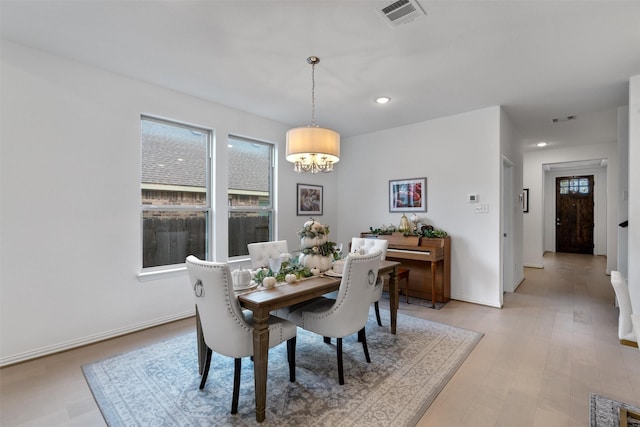 dining room featuring a chandelier and light hardwood / wood-style floors