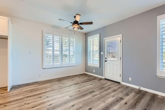 foyer entrance featuring ceiling fan and light wood-type flooring