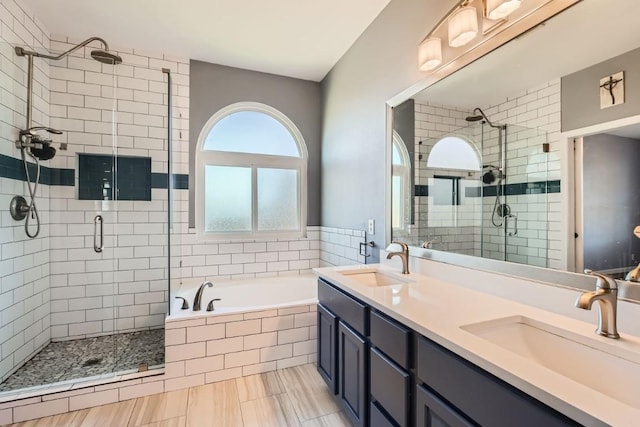 bathroom featuring plus walk in shower and vanity