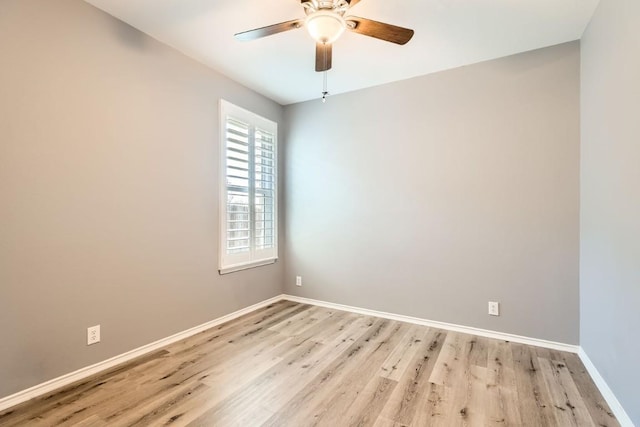 spare room with ceiling fan and light wood-type flooring