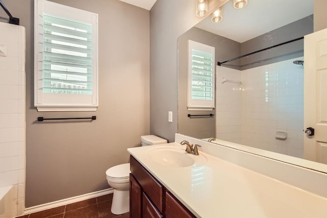 full bathroom featuring tiled shower / bath, tile patterned flooring, vanity, and toilet