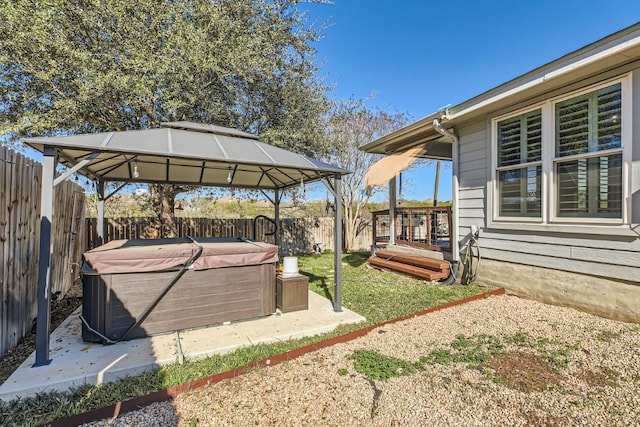 view of yard featuring a gazebo, a wooden deck, and a hot tub