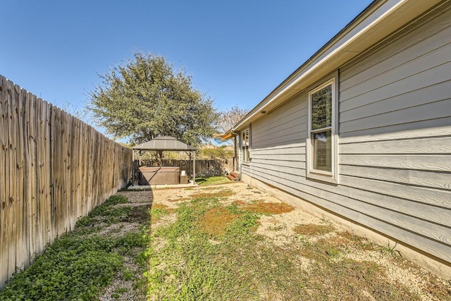 view of yard featuring a gazebo and a hot tub