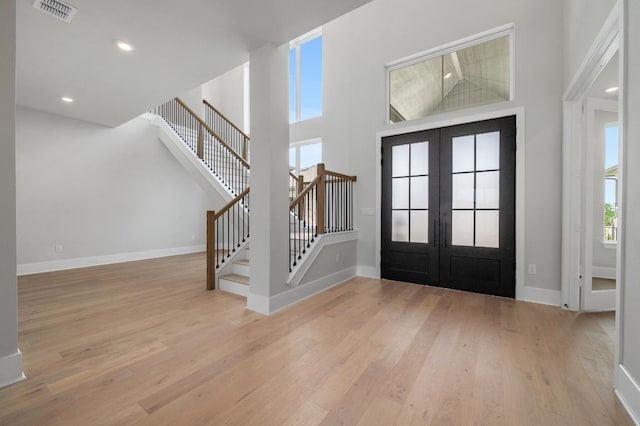 917 Bristol Creek Bnd, Lakeway, TX 78738 - entrance foyer with french doors, stairs, wood finished floors, recessed lighting, and a high ceiling