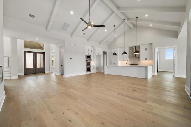 917 Bristol Creek Bnd, Lakeway, TX 78738 - unfurnished living room with a ceiling fan, high vaulted ceiling, light wood-style floors, beam ceiling, and recessed lighting