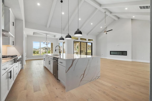 917 Bristol Creek Bnd, Lakeway, TX 78738 - kitchen featuring stainless steel appliances, white cabinets, a large island with sink, a chandelier, and recessed lighting