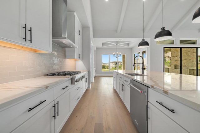 917 Bristol Creek Bnd, Lakeway, TX 78738 - kitchen featuring wall chimney range hood, stainless steel appliances, decorative backsplash, beam ceiling, and light wood-type flooring