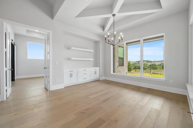 917 Bristol Creek Bnd, Lakeway, TX 78738 - unfurnished dining area featuring light wood-style flooring, a chandelier, beam ceiling, coffered ceiling, and built in shelves