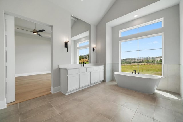 917 Bristol Creek Bnd, Lakeway, TX 78738 - full bathroom featuring a soaking tub, vanity, tile patterned flooring, a ceiling fan, and high vaulted ceiling