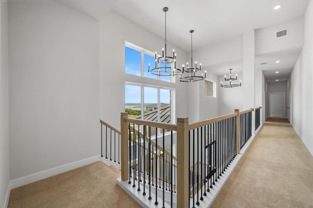 917 Bristol Creek Bnd, Lakeway, TX 78738 - corridor with an upstairs landing, light carpet, a chandelier, recessed lighting, and a towering ceiling
