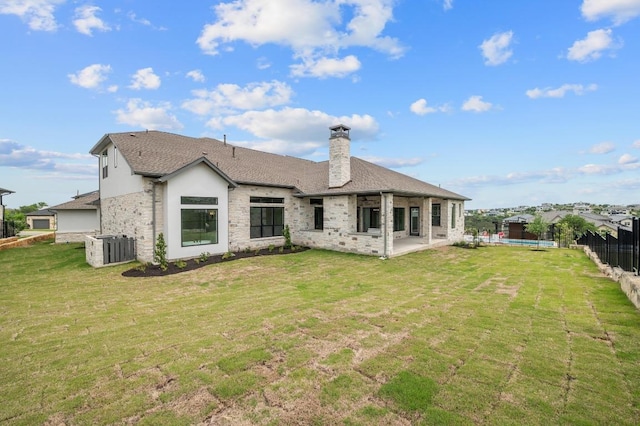 917 Bristol Creek Bnd, Lakeway, TX 78738 - rear view of house featuring a chimney, a patio, and roof with shingles