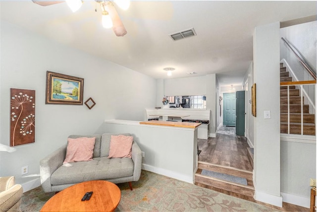 sitting room featuring hardwood / wood-style floors and ceiling fan