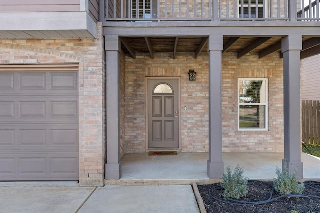 doorway to property with a balcony and a garage