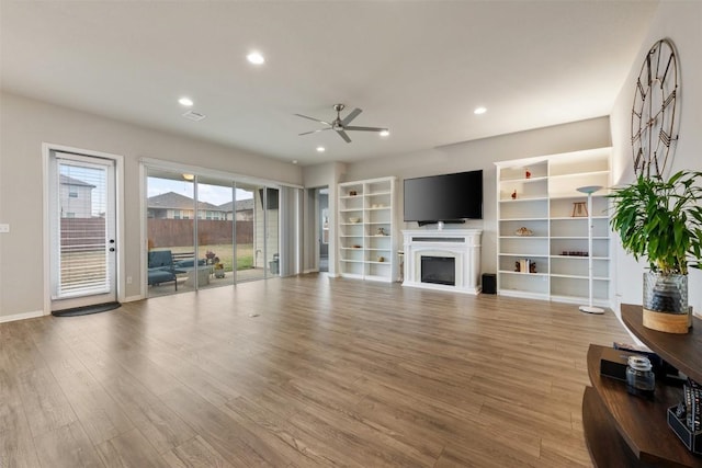 living room featuring ceiling fan and light wood-type flooring