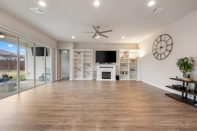 unfurnished living room with ceiling fan and light wood-type flooring