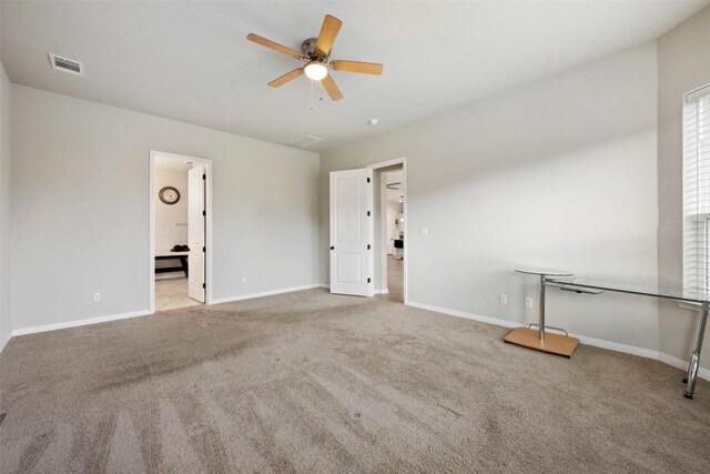 spare room featuring ceiling fan and light colored carpet