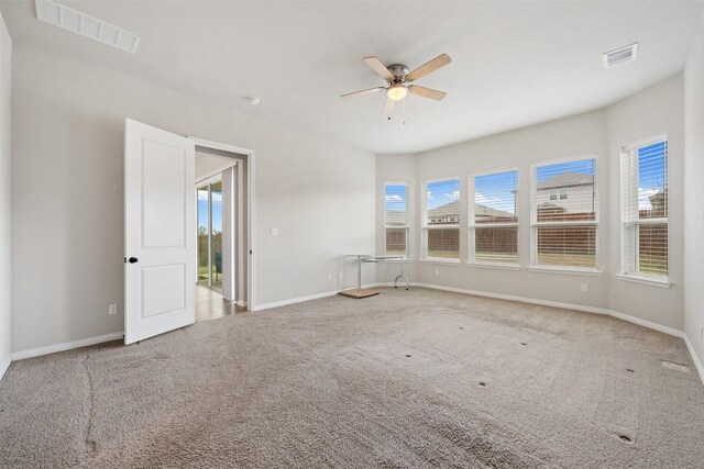 carpeted empty room featuring ceiling fan