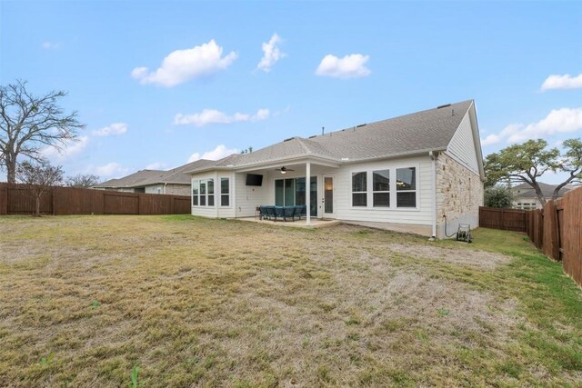 back of property with a patio area, ceiling fan, and a yard