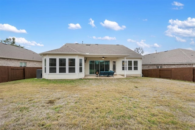 rear view of property featuring ceiling fan, cooling unit, a yard, and a patio