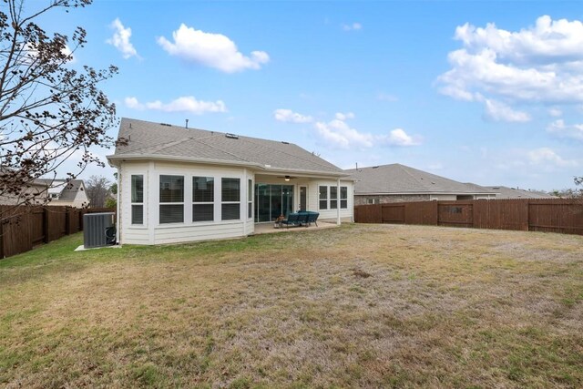 back of property with central AC unit, ceiling fan, a yard, and a patio