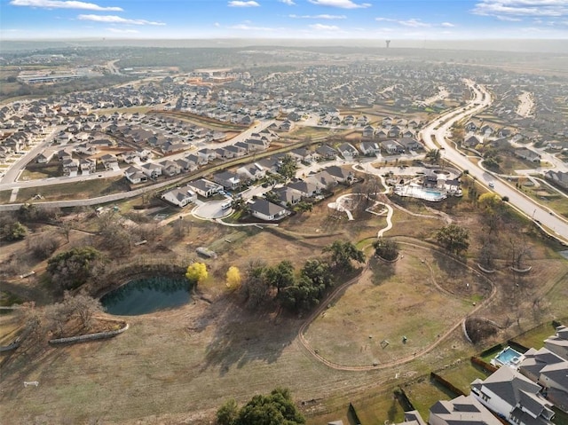 aerial view of property and surrounding area featuring nearby suburban area
