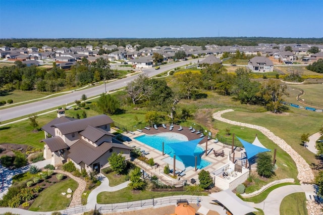 aerial perspective of suburban area featuring a pool